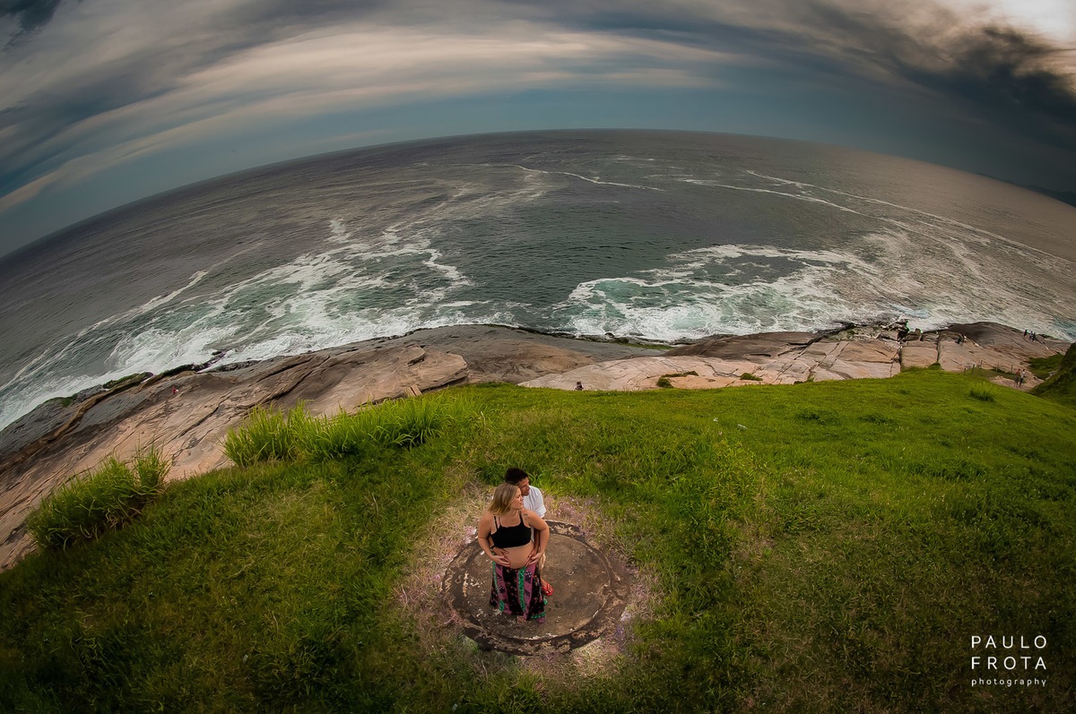 fotografia aérea do casal, com praia ao fundo e horizonte.