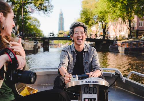 Vacation Photography of Booking Your Own Boat in Amsterdam: A Summer Afternoon on the Canals