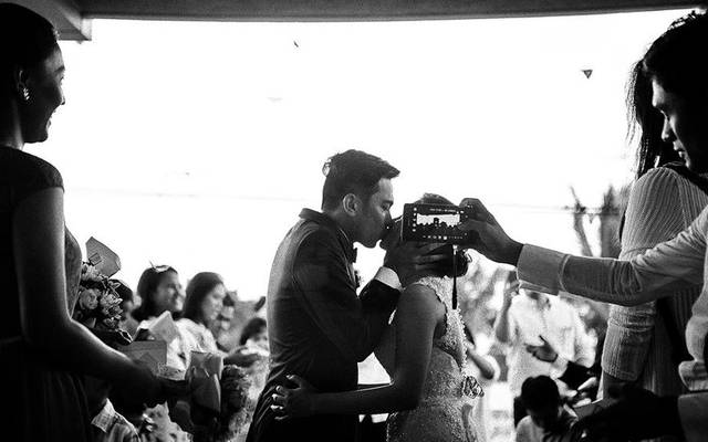 Foto do beijo é estragada por convidado em casamento