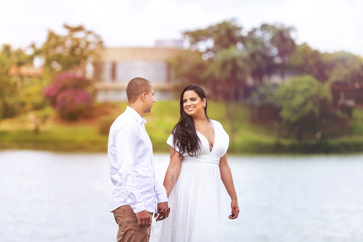 Pré Casamento do Guilherme e Renata de mãos dadas tendo fundo os trações do belo projeto arquitetônico do Museu de Arte da Pampulha do mestre Oscar Niemeyer