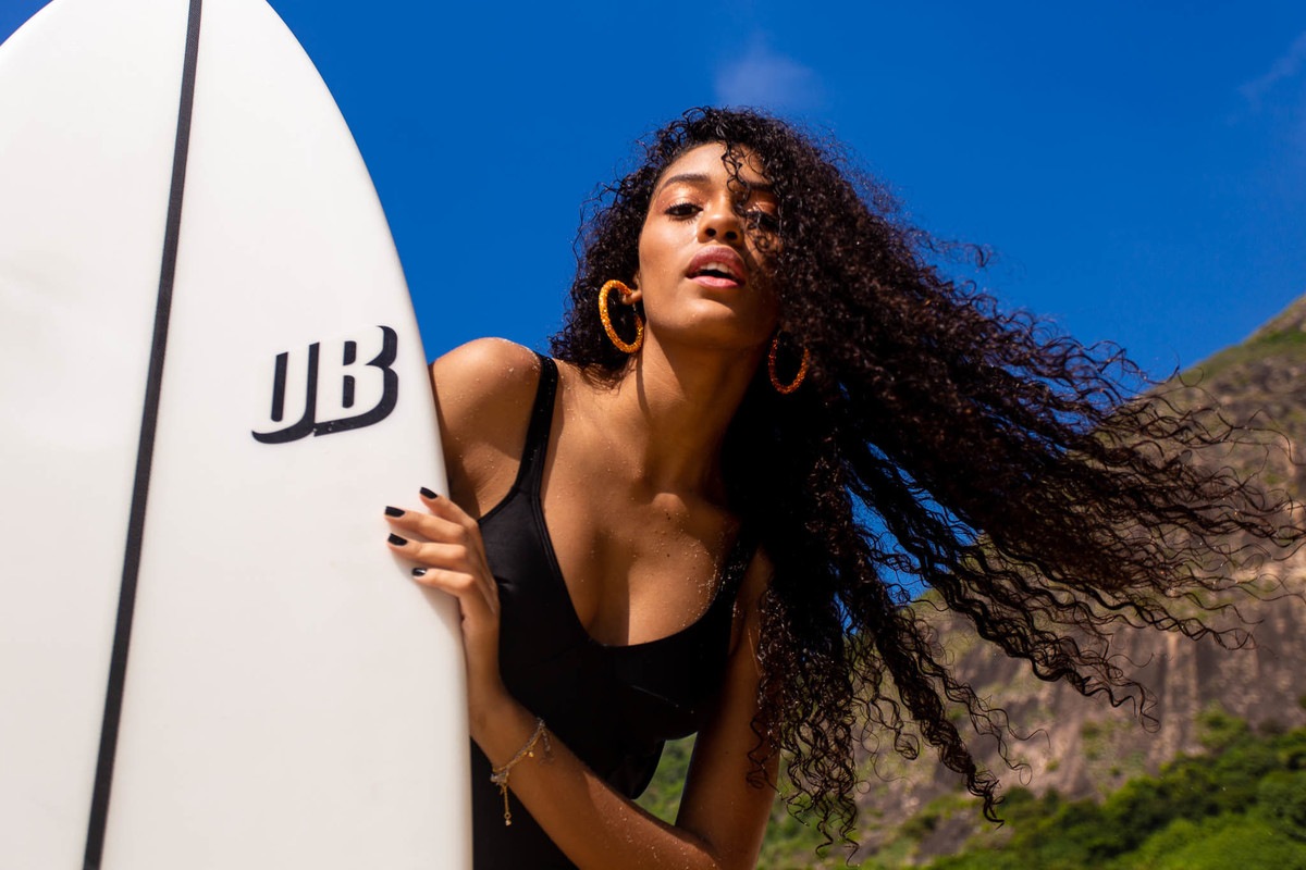 Jovem modelo posando pra foto na praia.