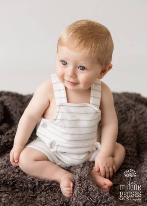 bebê ruivo 7 meses menino fundo claro sentado'