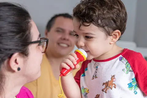 Fotografia de família com criança brincando com os pais'