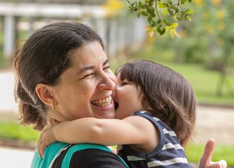 Fotografia de família com bebê beijando a mãe'
