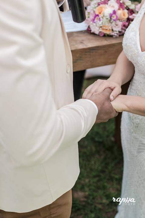 Rapha Drummond fotografa noivos de mão dadas em foco.'