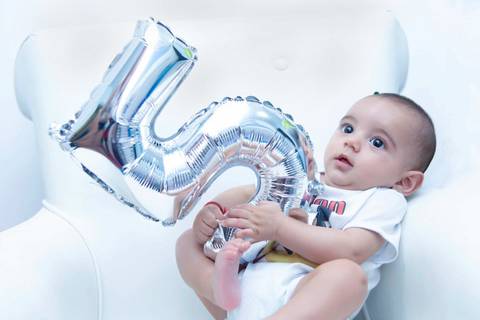 Acompanhamento de bebe na poltrona do quarto, foto do  bebe com o numero cinco. Ensaio cinco meses. Mesversário. Fotografa tatuape.  Ensaio infantil em casa ou estudio'