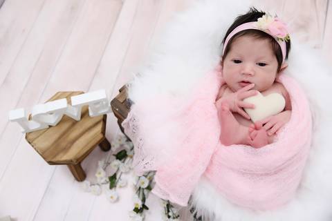 ensaio newborn em cenario fotografico, bebe abraçando coração, fotografa newborn tatuape'