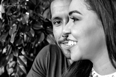 homem por trás de mulher olhando para frente e mulher com rosto de lado de olho fechado e sorrindo '