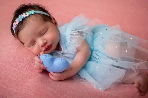 Fotografia da bebê Helena, durante o ensaio newborn, no estúdio em São José - SC. Foto pela fotógrafa Carol Zimmermann
'