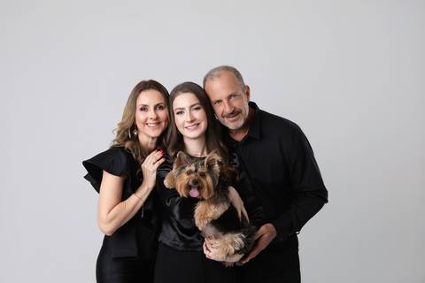 o: Retrato de família em estúdio com formanda de Medicina. Maria Eduarda comemorando a formatura com os pais e o cãozinho de estimação.'