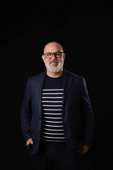 Ensaio corporativo masculino com fundo escuro. Retrato de estúdio elegante e de alto contraste focado em autoridade e liderança profissional.'