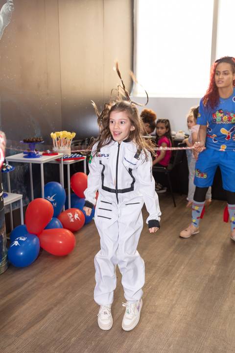 Registro lúdico e dinâmico de infância. Anna comemorando o aniversário de 6 anos com voo livre no túnel de vento do iFly, Distrito Federal.'