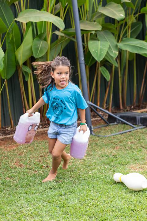 Brincadeiras e gincanas ao ar livre em aniversário infantil. Registro dinâmico de corrida de saco e atividades recreativas focadas no bem-estar e na diversão em Brasília.'