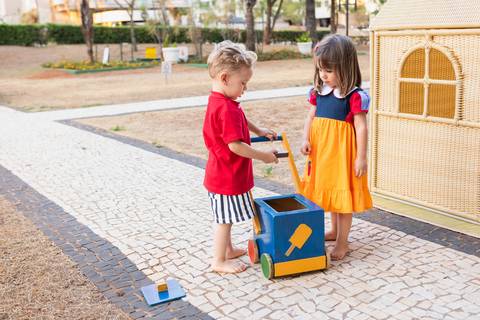 Brincadeiras e interações lúdicas em aniversário infantil de 3 anos. A aniversariante Liz se divertindo com oficinas criativas, casinha de brinquedo e atividades recreativas.'