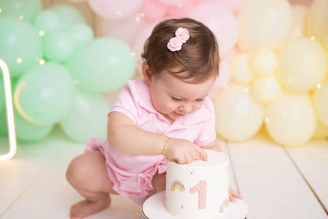 Desenvolvimento infantil e fase de descobertas do bebê. Cecília interagindo com seu bolo de aniversário de um ano.'