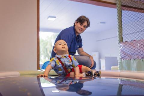 pai e bebê aniversariante pula pula baby registrado pela fotógrafa Letícia Leticia Franco em brasília brasilia df'