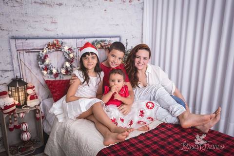 ensaio de natal infantil criança touca de papai noel 2019 brasilia df registrado pela fotógrafa letícia franco quarto do papai noel cama arvore guirlanda  miguel alice elena com a mamãe '