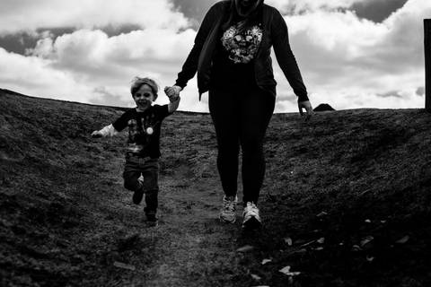 mãe e filho brincando ensaio em família no parque fotografia preto e branco'