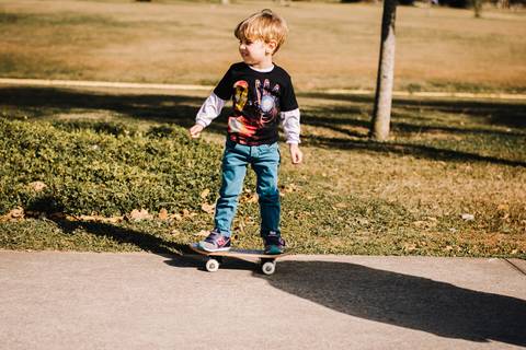 ensaio criança andando de skate no parque'