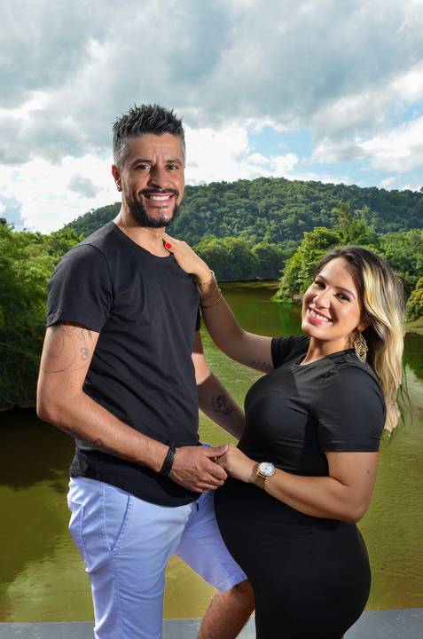 Foto do Casal Sorrindo Olhando para a Câmera Em Cima da Linha do Trem com o Rio Passando Embaixo em Guararema - SP, Foto Feita Pela Priscila Felix Fotógrafa de Família, Casamento e Ensaios '