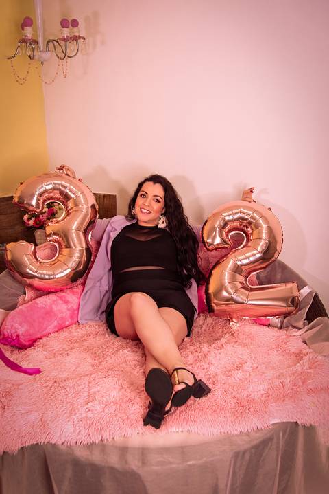 Foto da Filha Sentada Num Banco de Vime Redondo Com Balões Numerais 32 de Seu Aniversário em São Paulo - SP, Foto Feita Pela Priscila Felix, Fotógrafa de Família, Casamento e Ensaios '