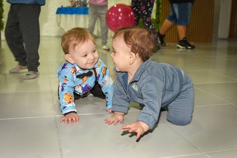 Foto do Aniversariante e da Priminha Engatinhando Se Olhando e Rindo No Chão No Buffet Momento Mágico Em São Paulo - SP, Foto Feita Pela Priscila Felix Fotógrafa de Família, Casamento e Ensaios '