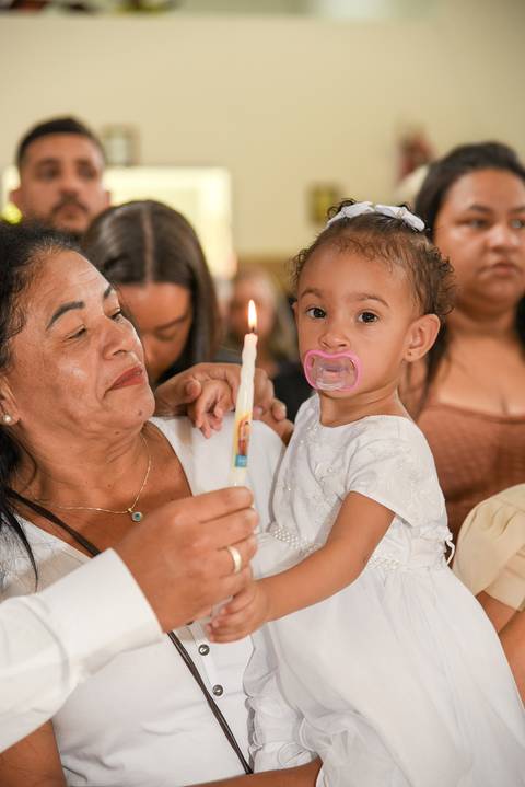 Fotografia da Batizado No Colo da Avó Com a Vela do Batismo Acesa Na Igreja São José em São Paulo, SP Feita por Priscila Felix Fotógrafa de Casamentos, Ensaios e Família'