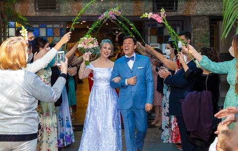 foto dos noivos saindo na porta da igreja no túnel de flores, foto casamento gruta alphaville, foto casamento alphaville, foto casamento barueri'