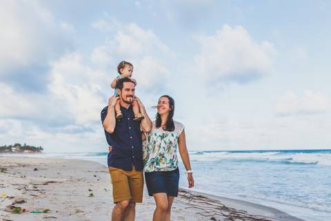 familia caminhando na praia'