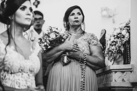 mãe do noivo segurando o buquê da noiva'