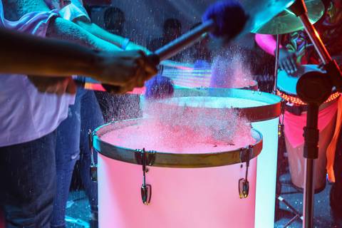 Tambor em destaque, com um efeito de purpurina espalhando-se ao redor, capturando a energia e o brilho do show no Evento de Fim de Ano GPA 2024 na sede em São Paulo.'