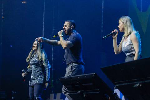 Outra imagem dos três cantores da banda no palco do Espaço Unimed em São Paulo, com foco em suas expressões vibrantes enquanto performam para o evento do GPA.'