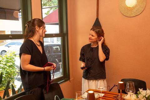 Participantes do evento Westwing conversando animadamente e interagindo no ambiente decorado do Clandestina Restaurante em São Paulo, evidenciando o networking entre influenciadores digitais.'