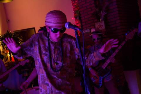 Vocalista da banda Ciência de Chico em destaque, vestido com trajes que remetem a Chico Science, performando com intensidade. (reFestança, São Paulo) fotografia Bruno Arita'