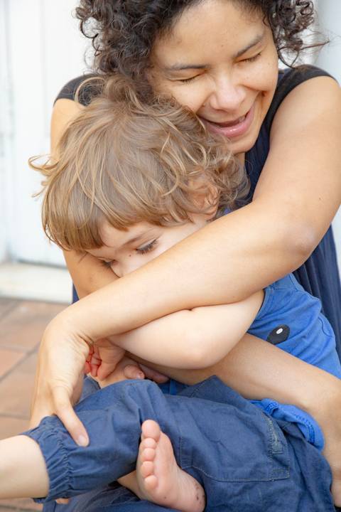 Mãe abraçando carinhosamente o filho pequeno no colo, em uma fotografia que transmite ternura e amor materno. (Ensaio de Família, São Paulo, Fotógrafo Bruno Arita)'