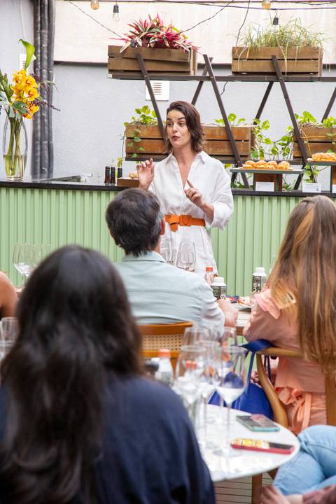 Sommelier Clara Mei em plano aberto, falando para o público sobre os vinhos da Arpuro. (Westwing, Vila Madalena, São Paulo, Bruno Arita)'