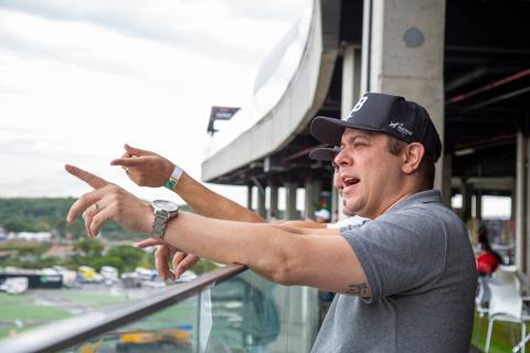 Participantes conversando e apontando para a pista em plano fechado nos participantes. (Stock Car, Evento Corporativo, Fotos Bruno Arita)'