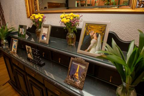 Aparador com fotos de família e recordações de viagens em festa de aniversário no Baby Beef Jardim. Registro por Bruno Arita.'