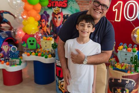 Aniversariante ao lado do papai, orgulhoso e sorridente'