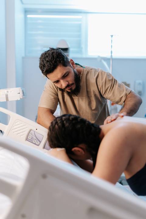 Foto do pai apoiando a gestante durante as contrações'