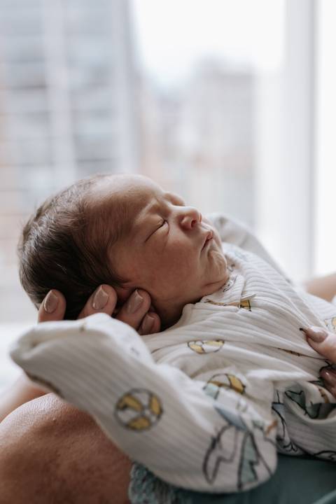 Foto aproximada do rosto do bebê dormindo.'