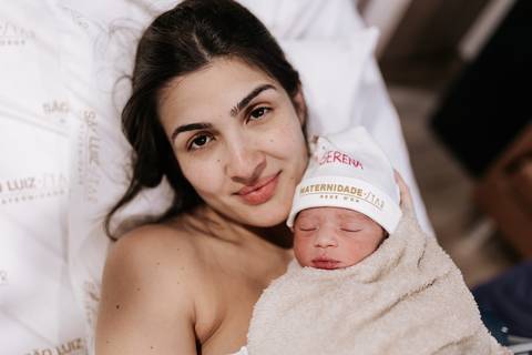 Foto da mãe e bebê em contato pele a pele.'