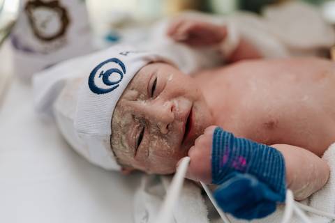 Foto de close do rosto do Guilherme com a touca da Pro Matre.'