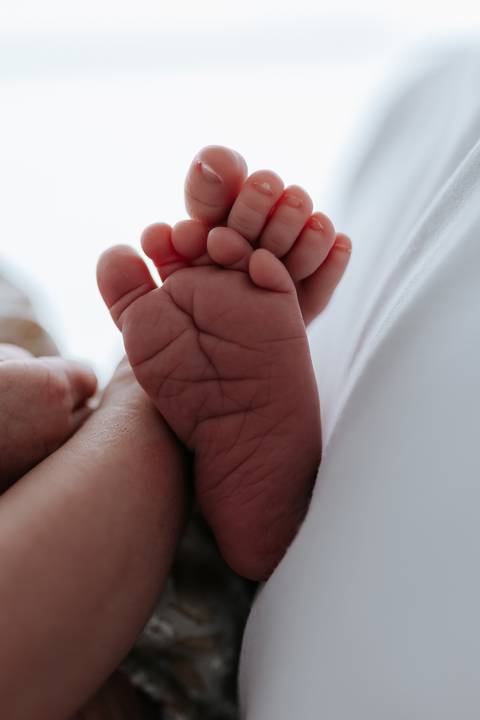 Foto em detalhe dos pezinhos da bebê Olívia.'