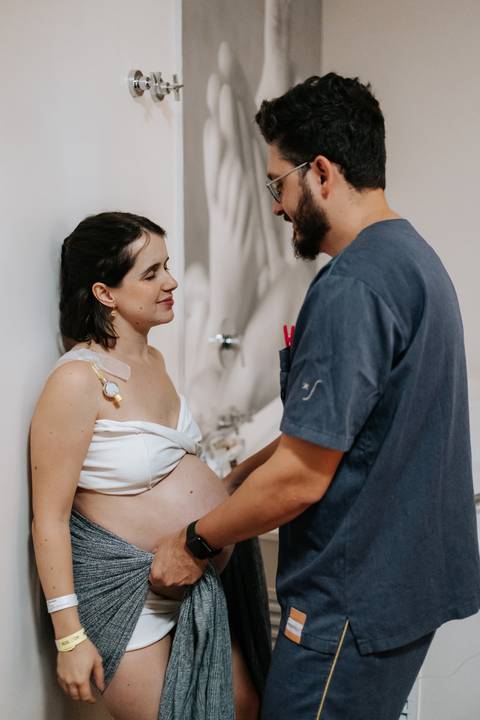 Foto da gestante trocando um olhar de cumplicidade com o acompanhante.'
