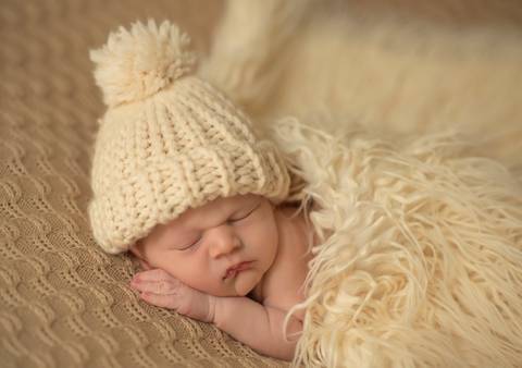 bebê com touca de tricô e pêlo'