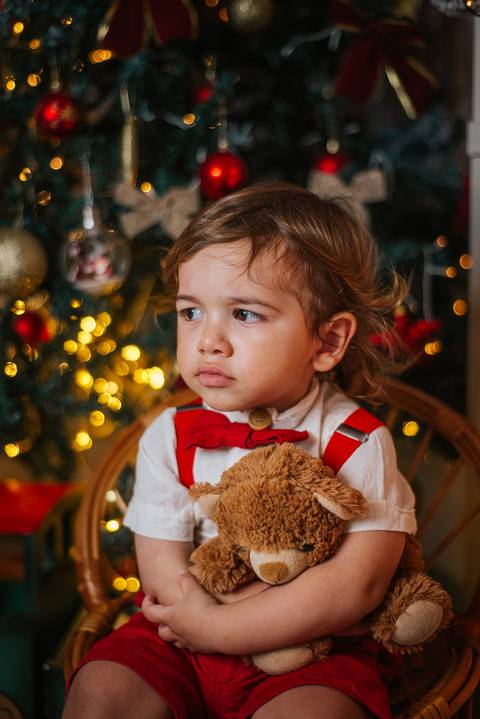 Ideia de foto divertida de criança com gorro vermelho natalino.'