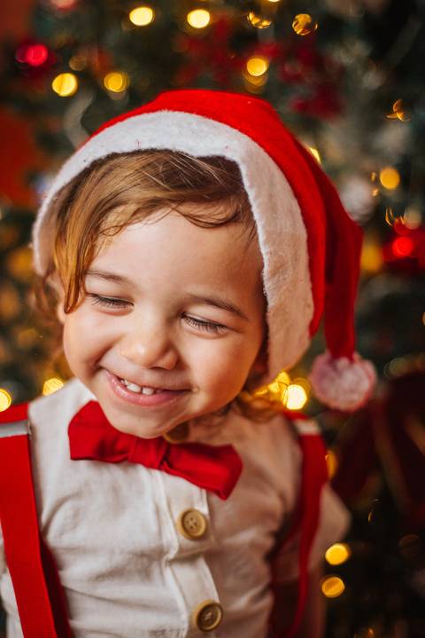 Casal abraçado em cenário natalino romântico.'