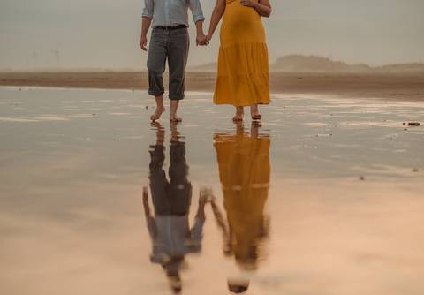 detalhe de casal caminhando na praia em ensaio gestante
'