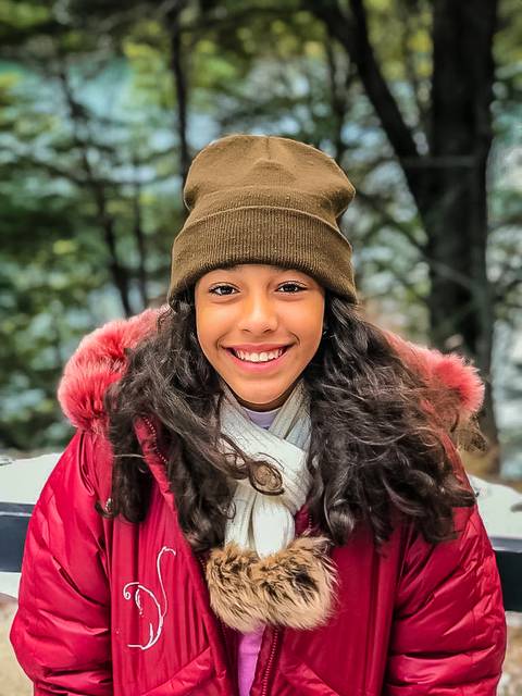 Adolescente de touca marrom e jaqueta vermelha na argentina'